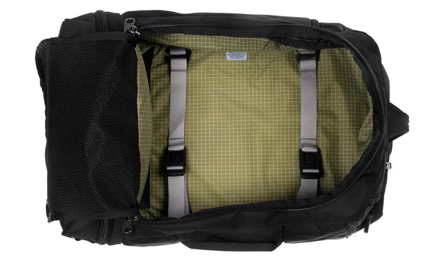 An open Techonaut 45 with a Black exterior and a Taiga (sage green) interior.